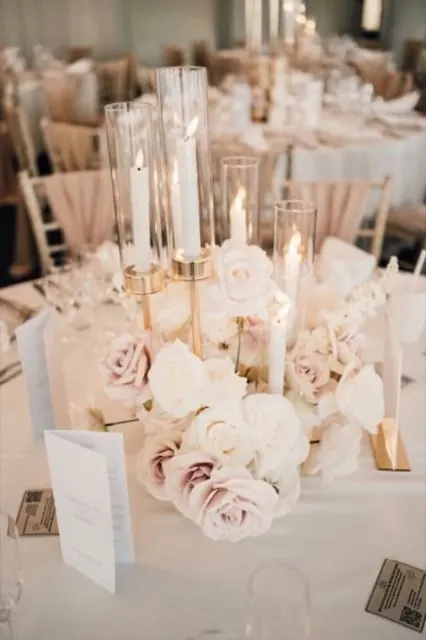 Blush and ivory roses with gold candlesticks and tall glass candles